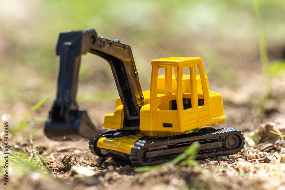 Re-enacting a building lot with toys in a sandbox Re-enacting a building lot with toys in a sandbox