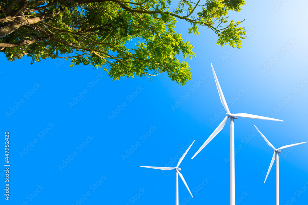 Wind Turbines on blue sky and green tree, clean energy sustainable for future