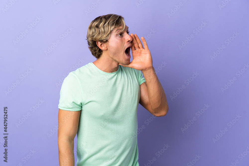 English man over isolated purple background shouting with mouth wide open to the side English man over isolated purple background shouting with mouth wide open to the side