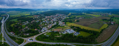 Fototapeta Naklejka Na Ścianę i Meble -  Aerial view of the village Traunricht in Germany on a cloudy day in spring