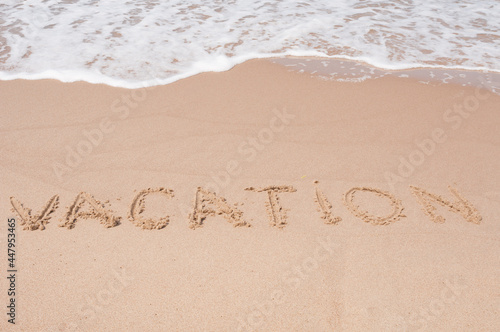 Vacation Inscription on a sandy sea coast