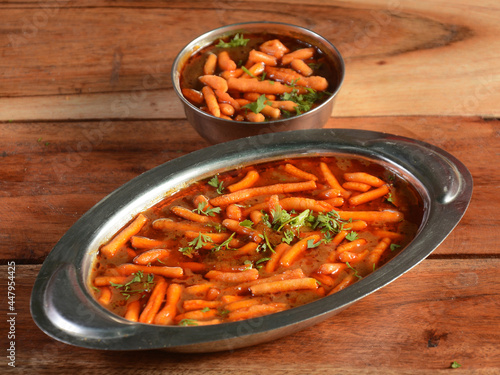 Sev Bhaji or Shev Sabji or Kathiyavadi Dhaba Style Gathiya nu shaak - spicy, sweet and tangy tomato curry topped with crisp Ganthia or gathia photo