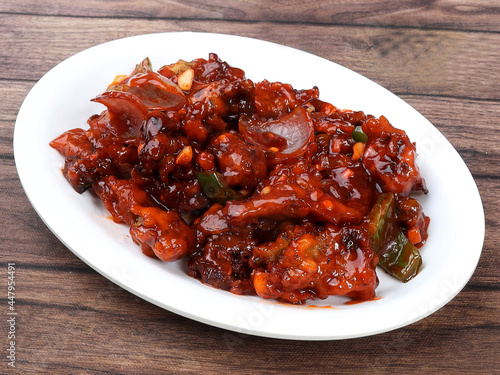 Veg Crispy is Batter Fried vegetables tossed with Chinese sauce tastes tangy. It's a popular Starters or appetizer in India. served over a rustic wooden table. selective focus