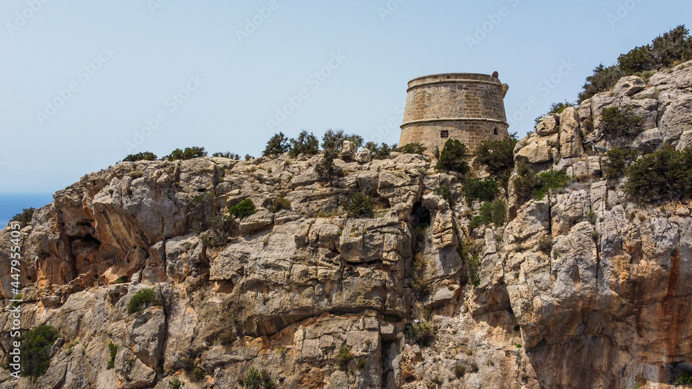 Torre des Savinar, a medieval defensive tower in the west of Ibiza island in the Balearic Islands, Spain - Built at the top of a rocky cliff overlooking the Mediterranean Sea