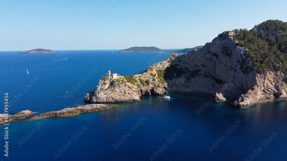 Aerial view of the abandonned lighthouse on the Punta Grossa cape, in the east of Ibiza island in the Balearic Islands, Spain - Ruins of a square based lighthouse with a round tower