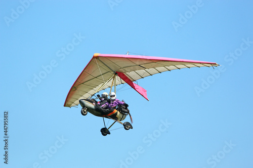 Valokuva Ultralight airplane flying in a blue sky
