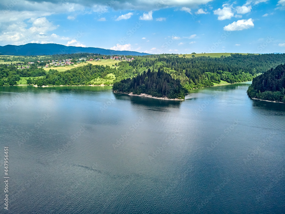 Fototapeta premium Beautiful aerial panoramic view of the Lake Czorsztyn (Polish: Jezioro Czorsztynskie) is a man-made reservoir on the Dunajec river, southern Poland, between the Pieniny and the Gorce Mountains