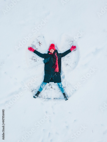 happy woman making snow angel
