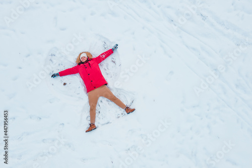 overhead top view of man making snow angel