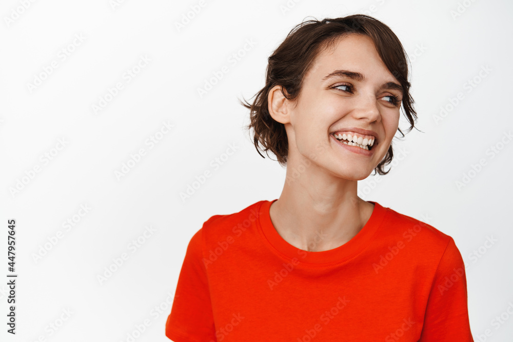 Close up portrait of carefree brunette girl laughing, smiling happy, looking aside, standing over white background Close up portrait of carefree brunette girl laughing, smiling happy, looking aside, standing over white background