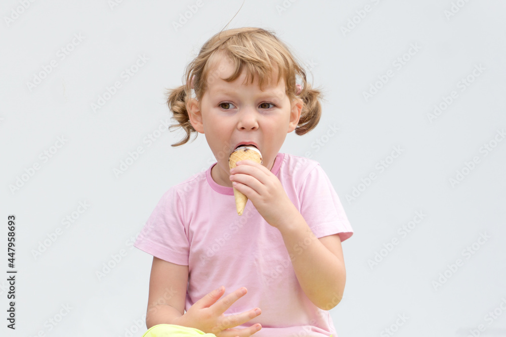 Little caucasian curly girl eating ice cream. Little caucasian curly girl eating ice cream.