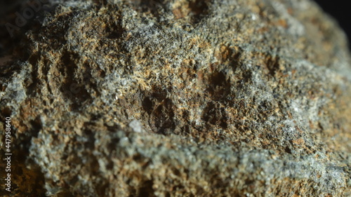 VOLCANIC ROCK WITH MINERALS  MACRO IMAGE WITH BLACK BACKGROUND