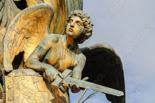 Marble statues on an angel that are part of one of the many monuments that exist in Rome, Italy.