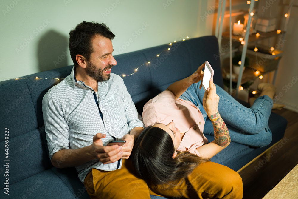 Happy boyfriend and girlfriend using social media Happy boyfriend and girlfriend using social media
