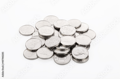 Close-up of a heap of 10 hryvnia coins  on a white background. Ukrainian coins