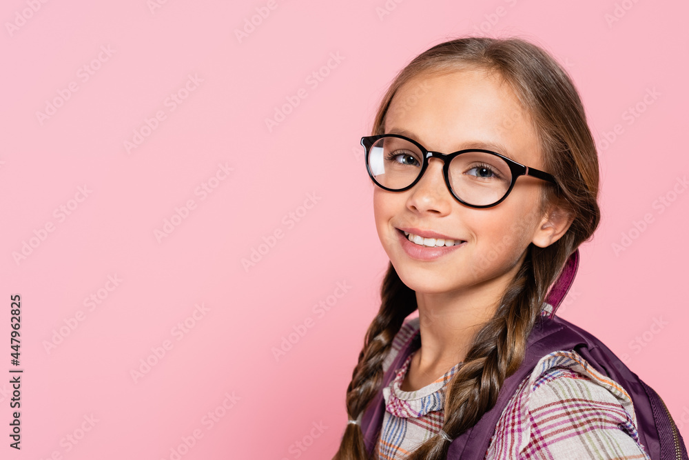 Portrait of smiling schoolkid in eyeglasses isolated on pink Portrait of smiling schoolkid in eyeglasses isolated on pink