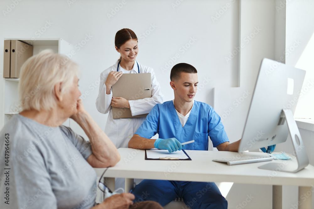 woman patient at doctor's appointment and nurse in hospital examination