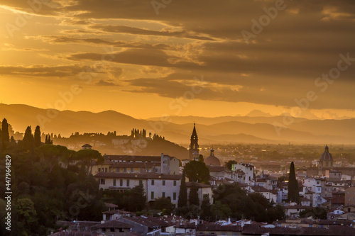 The hills surrounding the beautiful city of Florence  Italy at sunset  with the trees and church towers silhouetted