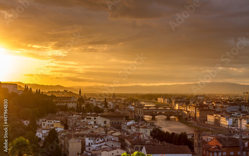 The cityscape of beautiful Florence, Italy, as the cloudy sky erupts with color as the sun sets