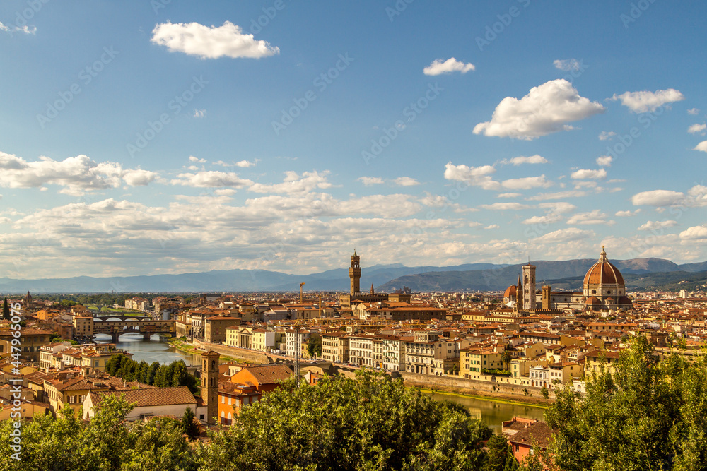 The cityscape of beautiful Florence, Italy, with fluffy clouds in the blue sky