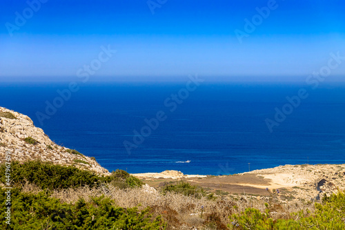 A view of the Mediterranean Sea of Cyprus from the viewpoint of Capo Greco National Park. A tourist motor boat is visible in the distance. © Photojulia