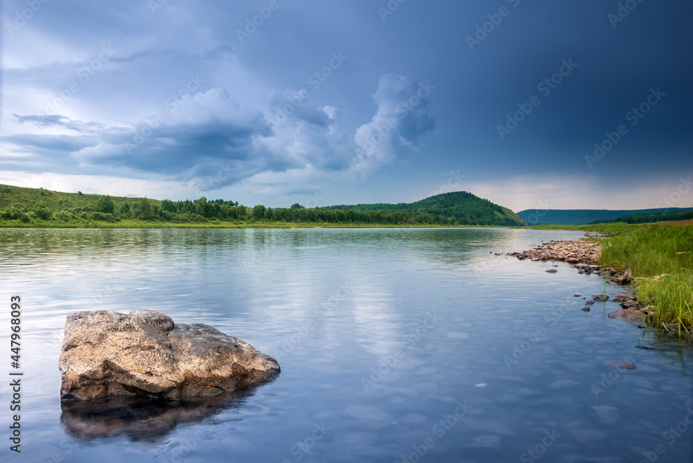Landscapes of Siberia. Evening landscape on the Kiya river. Mountains, forest, river and water at long exposure. Kemerovo region. Russia