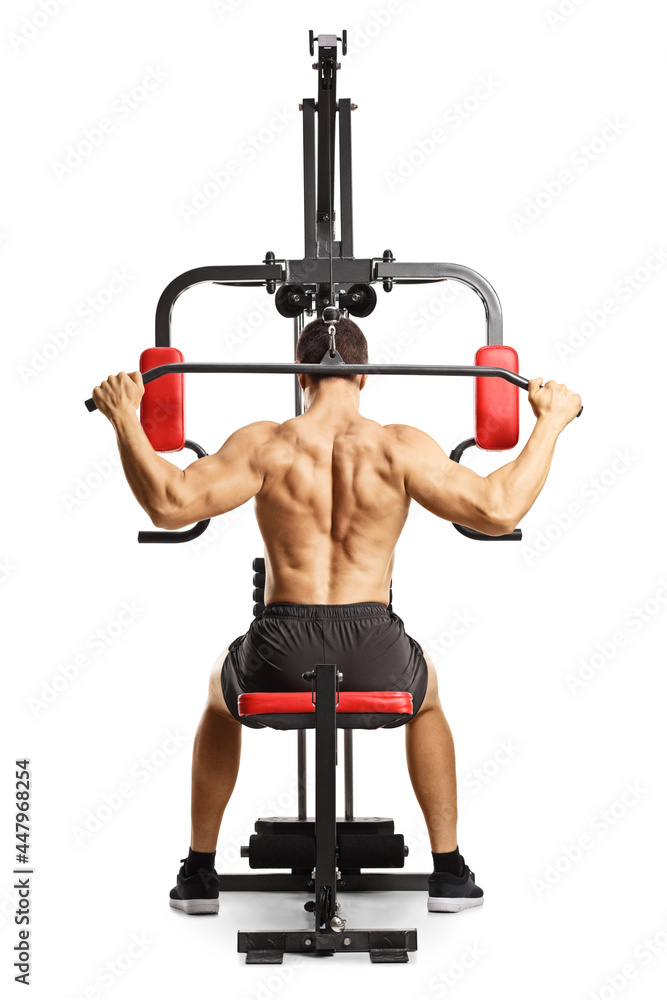 Obraz premium Shirtless musuclar man exercising back muscles with a bar on a fitness machine