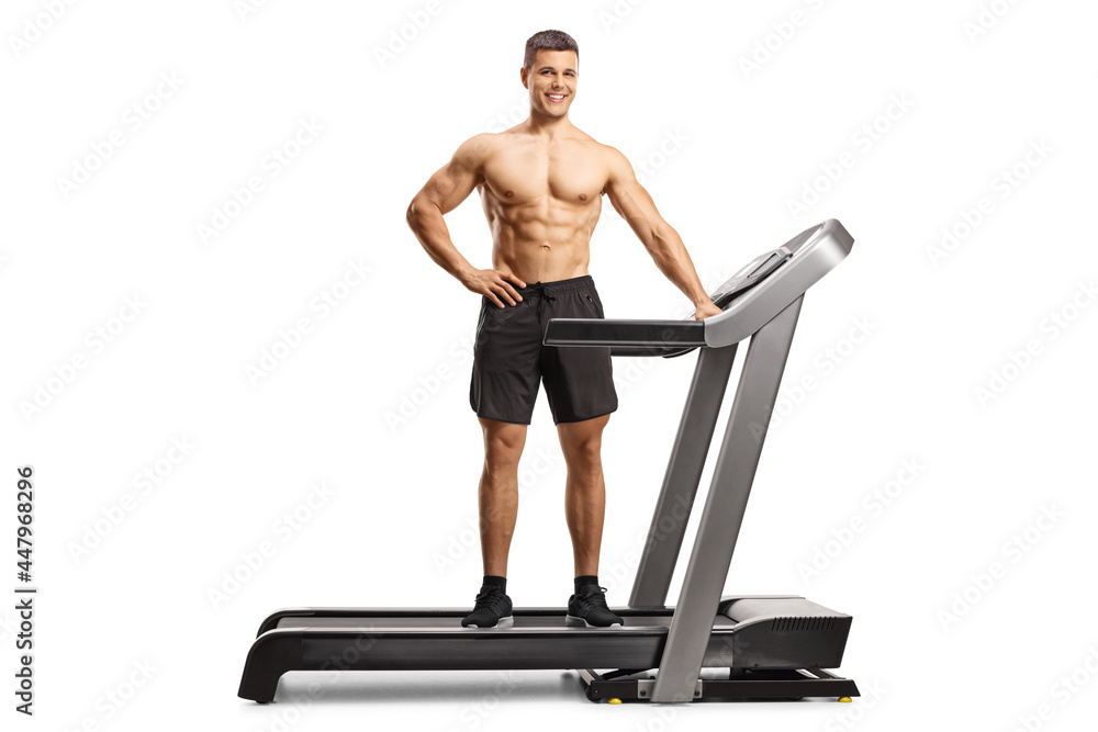 Fototapeta premium Full length shot of a bodybuilder posing on a treadmill