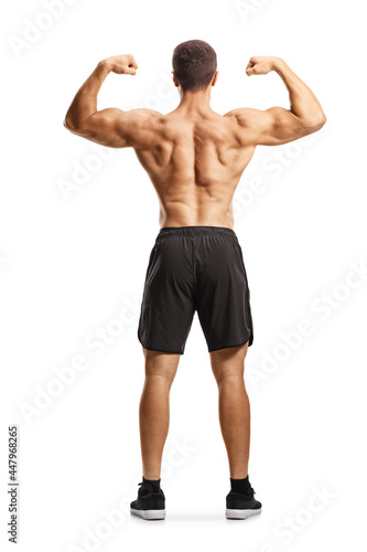 Rear view of a shirtless musuclar man flexing back muscles