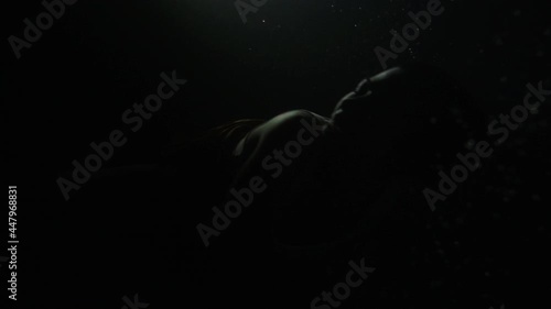 Woman comes out of the dark water photo