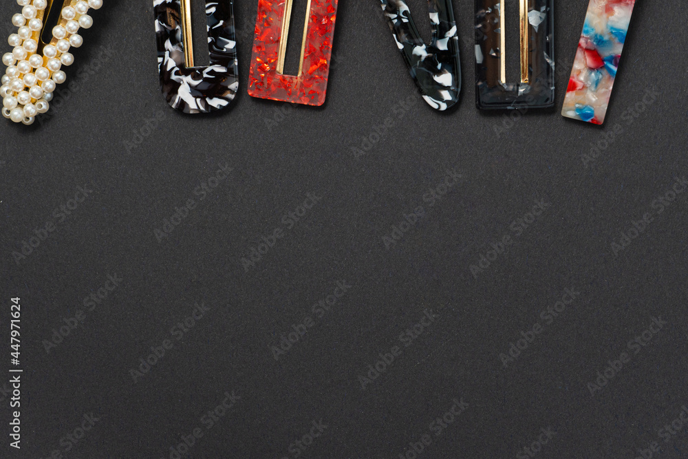 hair clips of different colours and different styles on a dark background hair clips of different colours and different styles on a dark background