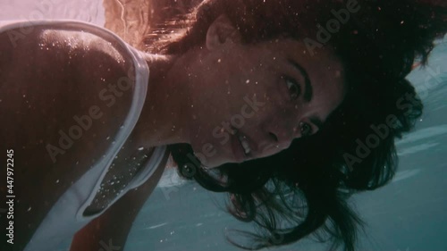 Young woman floats motionless in water