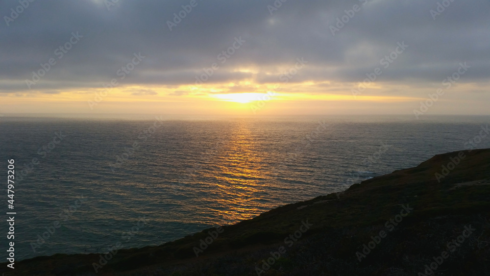 Gorgeous sunset over the ocean and a moody sky full of clouds at Ocean Beach in San Francisco, California Gorgeous sunset over the ocean and a moody sky full of clouds at Ocean Beach in San Francisco, California