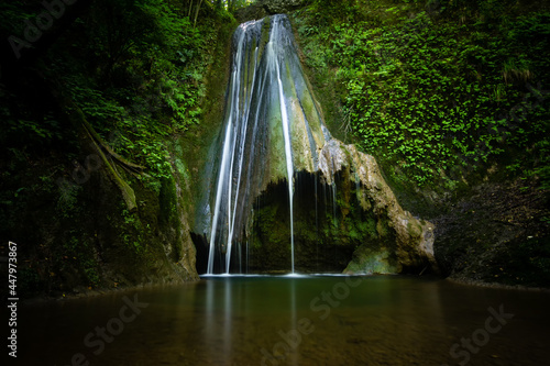Natural waterfall in a italian forest in Cimano, Friuli