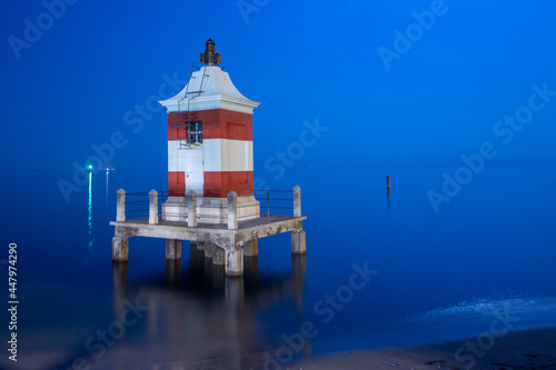Lignano Sabbiadoro, red lighthouse at night