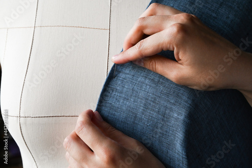 Fitting blue clothes on a mannequin. TAiloring and designing concept.Dressmaker. Fitting clothes on a dummy