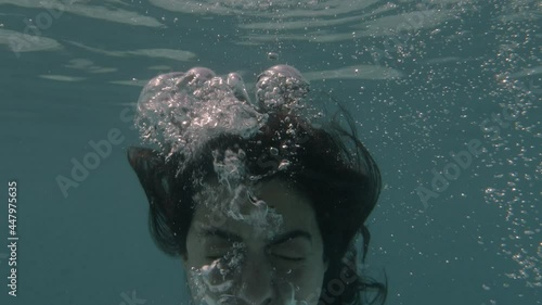 Woman yells at camera in water