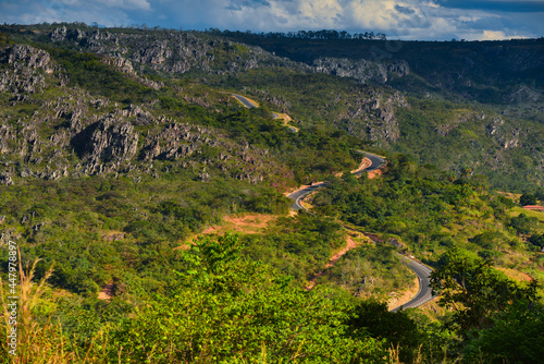 The sinuous mountain road on the rocky landscape of the Serra do Espinhaço range, between the towns of Serro and Diamantina, Minas Gerais, Brazil.