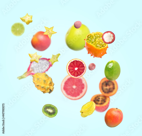 Fototapeta Naklejka Na Ścianę i Meble -  Different tasty exotic fruits flying on turquoise background