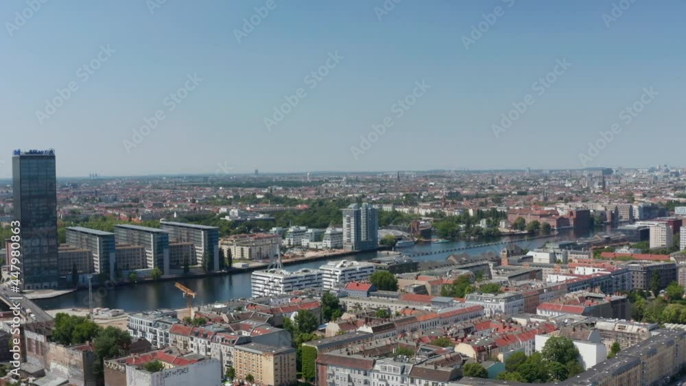 Forwards fly above urban neighbourhood towards Spree river. Treptower tall building complex on riverbank. Berlin, Germany Forwards fly above urban neighbourhood towards Spree river. Treptower tall building complex on riverbank. Berlin, Germany