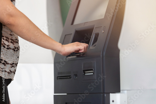 woman's hand on ATM transferring money or withdraw money