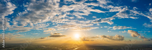 Aerial view of beautiful clouds and sun at sunset. © ABCDstock