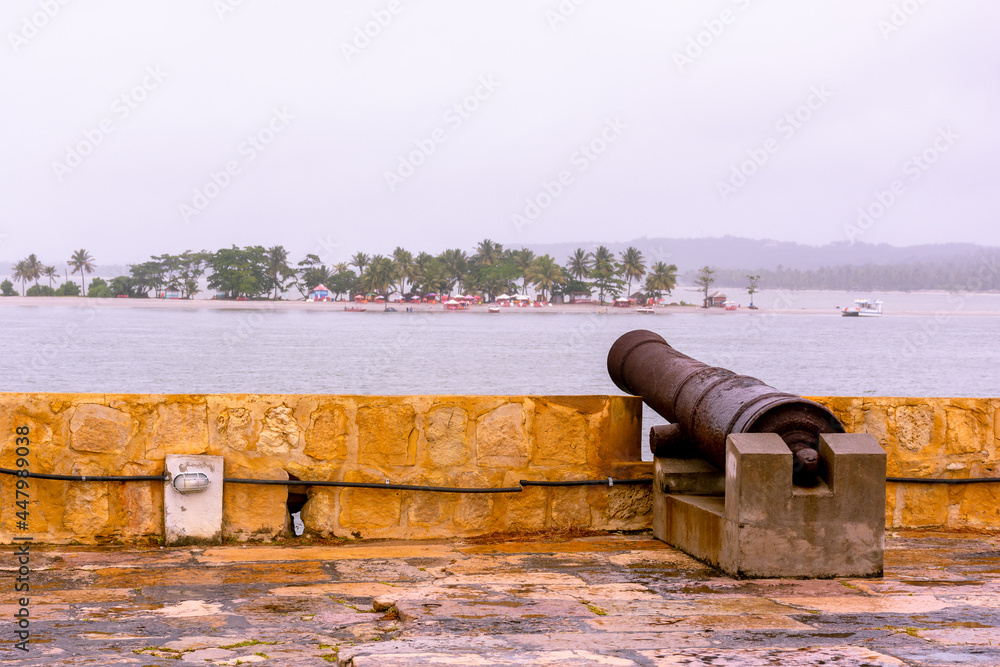 Cannons of the old fort Orange - Itamaracá - Cloudy sky with a view of the island of Coroa do Avião Cannons of the old fort Orange - Itamaracá - Cloudy sky with a view of the island of Coroa do Avião