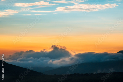 Clouds over the hills, beautiful colorful sky.