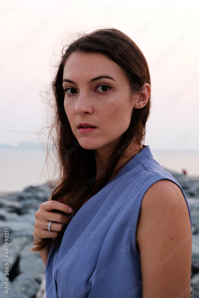 Portrait of pretty brunette wearing stylish blue top. Beautiful caucasian European female Portrait of pretty brunette wearing stylish blue top. Beautiful caucasian European female