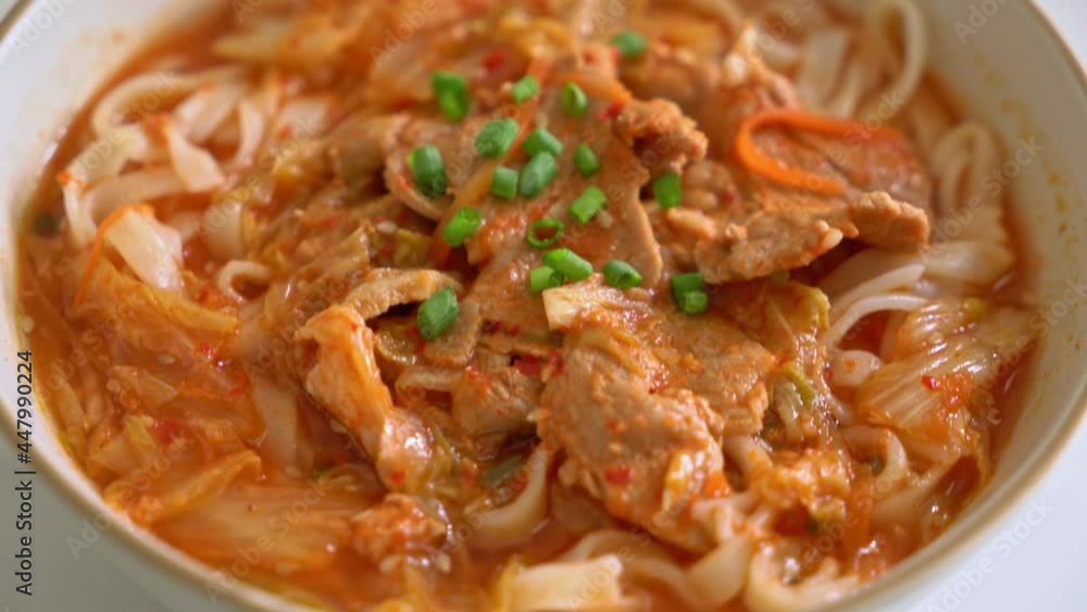 Korean udon ramen noodles with pork in kimchi soup - Asian food style Korean udon ramen noodles with pork in kimchi soup - Asian food style