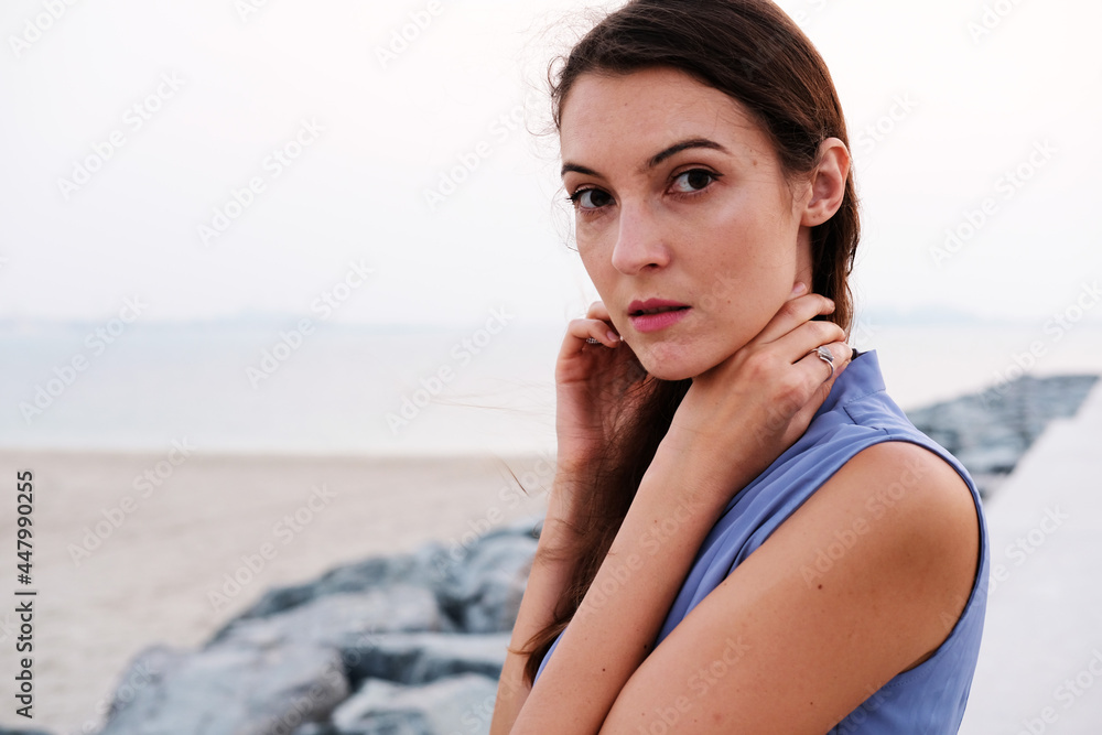 Portrait of pretty brunette wearing stylish blue top. Beautiful caucasian European female