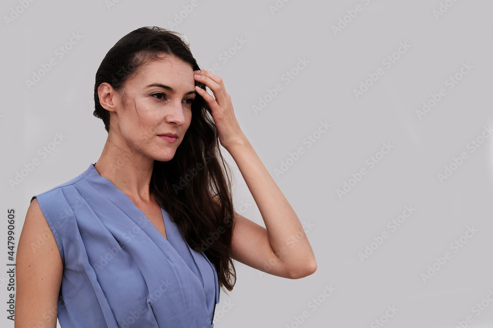 Portrait of pretty brunette wearing stylish blue top. Beautiful caucasian European female Portrait of pretty brunette wearing stylish blue top. Beautiful caucasian European female