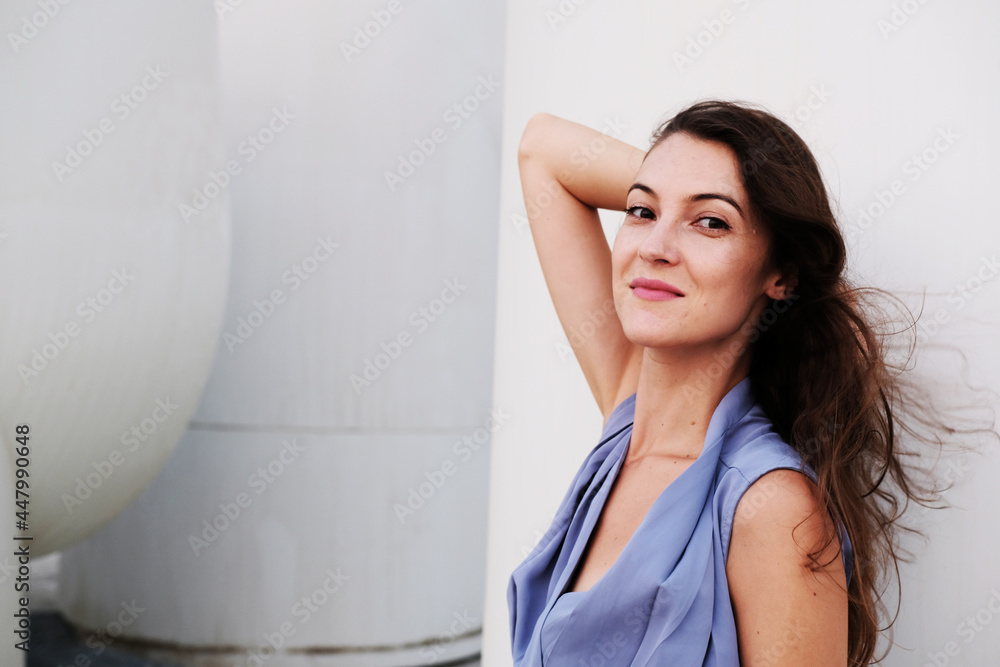 Portrait of pretty brunette wearing stylish blue top. Beautiful caucasian European female Portrait of pretty brunette wearing stylish blue top. Beautiful caucasian European female