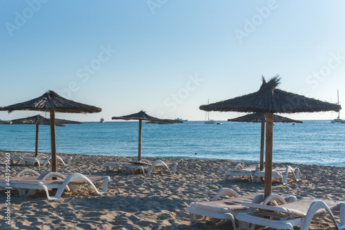 Straw umbrellas and sunbeds on the beach of Illetes in Formentera, Spain. © martinscphoto